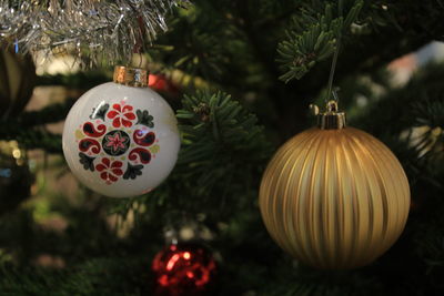 Close-up of christmas decorations hanging on tree