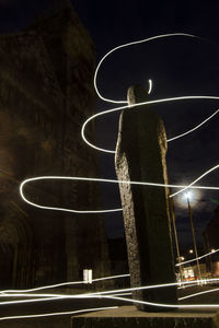 Low angle view of light trails on street at night