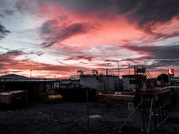 Silhouette buildings against sky during sunset