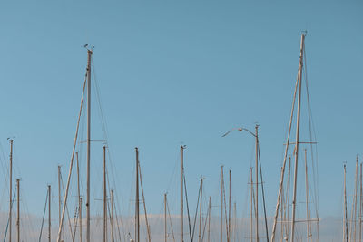Low angle view of electricity pylon against clear sky