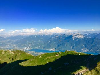 Scenic view of snowcapped mountains against blue sky
