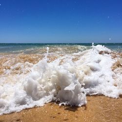 Close-up of sea wave against clear blue sky