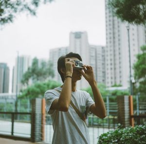 Man photographing in city