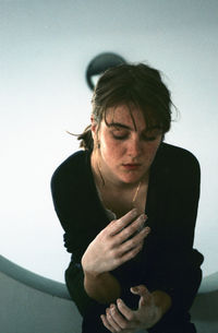 Close-up of young woman smoking indoors