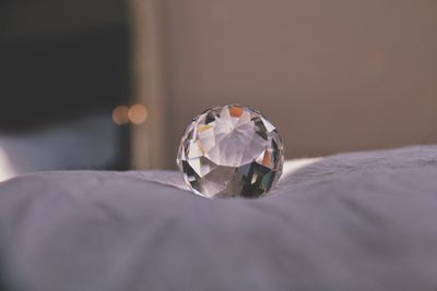 Close-up of diamond on bed at home