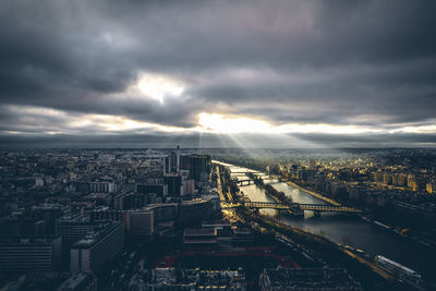 Aerial view of city against cloudy sky