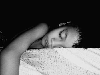 Portrait of woman sleeping on bed