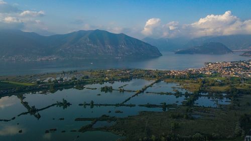 Scenic view of lake and mountains against sky