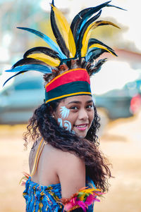 Portrait of smiling young woman standing outdoors