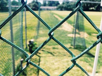 Close-up of chainlink fence against sky