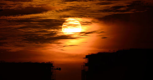 Scenic view of sunset over city