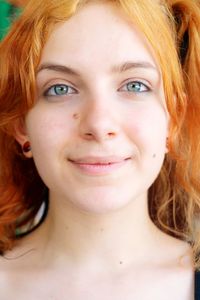 Close-up portrait of young woman with redhead