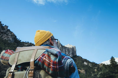 Man with backpack hiking in the mountains. sunny weather in spring.