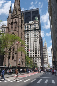 View of city street and buildings against sky