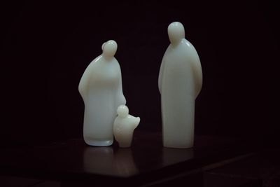 Close-up of chinese family figurines against black background