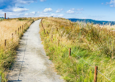 A path at dune peninsula park in ruston, washington seems to lead to the sky.