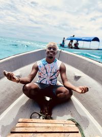 Portrait of young woman sitting on swimming pool
