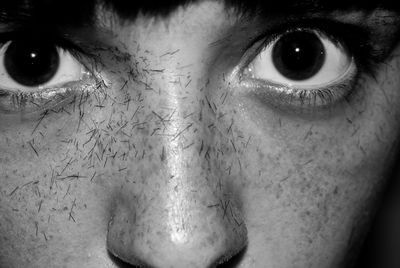 Close-up portrait of young woman with raised eyebrows