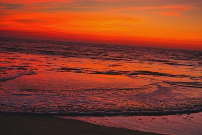 Scenic view of sea against romantic sky at sunset
