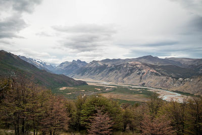 Scenic view of valley mountains against sky in autumn