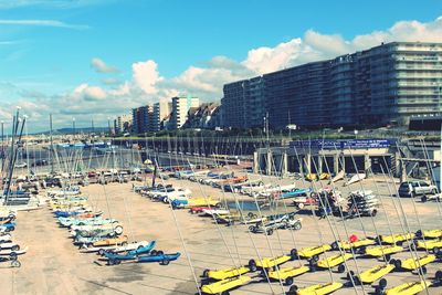 High angle view of sailboats in city against sky