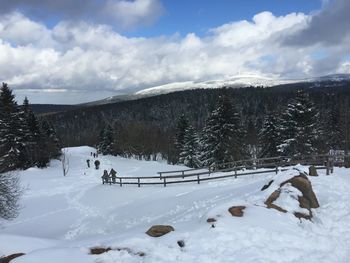 Scenic view of snow covered field against sky