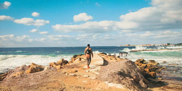 Panoramic view of rocks on beach against sky