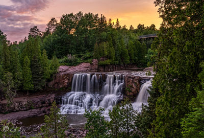 Scenic view of gooseberry falls  at sunset