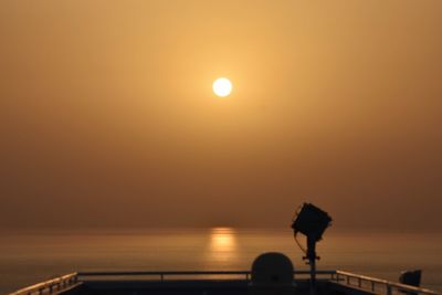 Scenic view of sea against orange sky