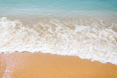 High angle view of waves rushing towards shore