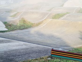 High angle view of street amidst field