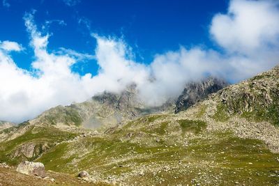 Scenic view of mountains against cloudy sky