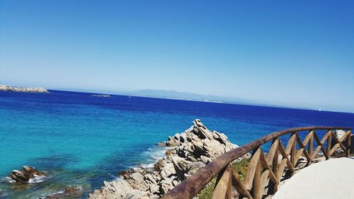 Scenic view of sea against clear blue sky