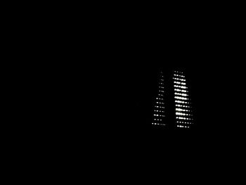 Low angle view of illuminated building against sky at night