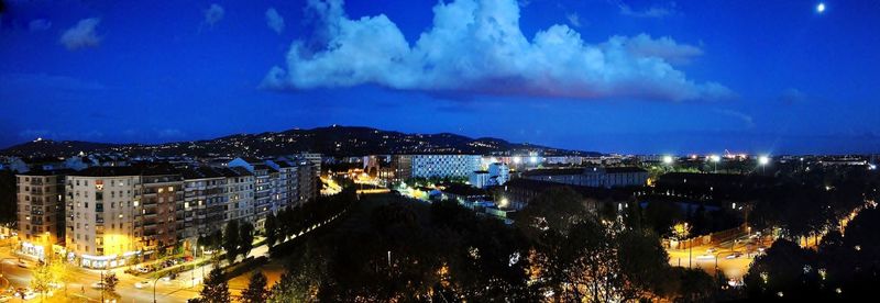 High angle view of illuminated buildings in city at night