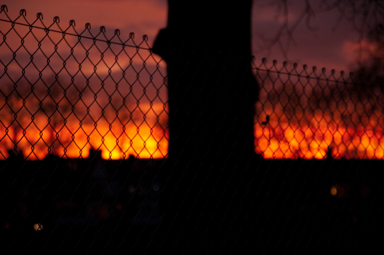 fence, chainlink fence, darkness, light, sunset, sky, security, night, orange color, protection, nature, evening, no people, reflection, wire, sign, dusk, outdoors, metal, cloud, warning sign, fire, silhouette, wire mesh, illuminated
