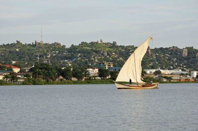 Sailboat sailing on sea against sky