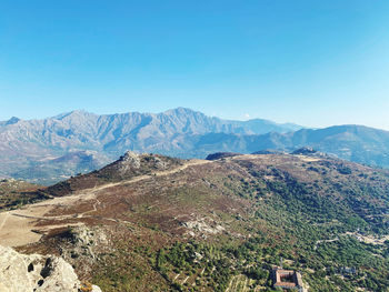 Scenic view of mountains against clear blue sky