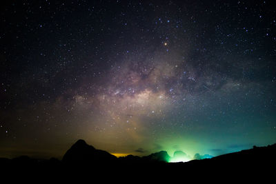 Scenic view of silhouette mountain against star field at night