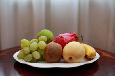 Close-up of fruits in plate on table