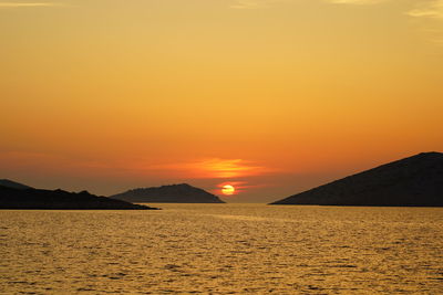 Scenic view of sea against romantic sky at sunset