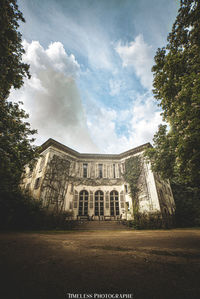 Low angle view of building against cloudy sky