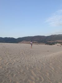Man on desert against sky