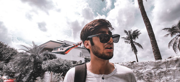 Portrait of young man against sky