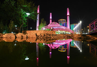 View of illuminated building in lake at night