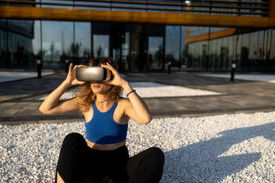 Young woman using mobile phone in gym