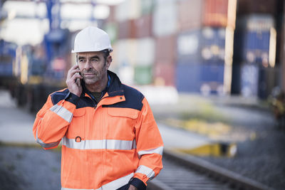 Portrait of man wearing hat standing outdoors