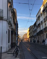 Railroad tracks amidst buildings against sky