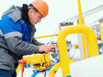 Side view of man working at construction site