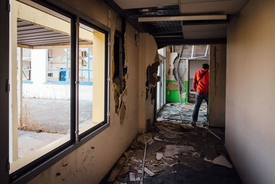 Rear view of mature man standing in abandoned building